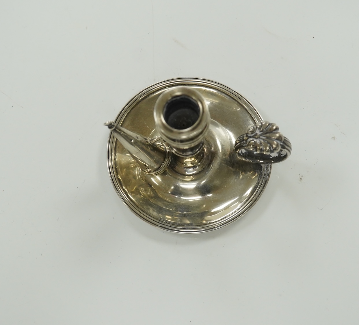 A George III miniature silver chamber stick, Emes & Barnard, London, 1815(a.f.), with matching extinguisher, base diameter 75mm. Condition - poor